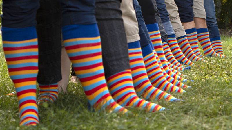 people wearing striped socks in the grass