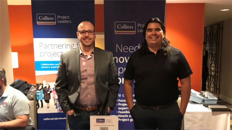 Colliers Project Leaders employees standing at a company booth