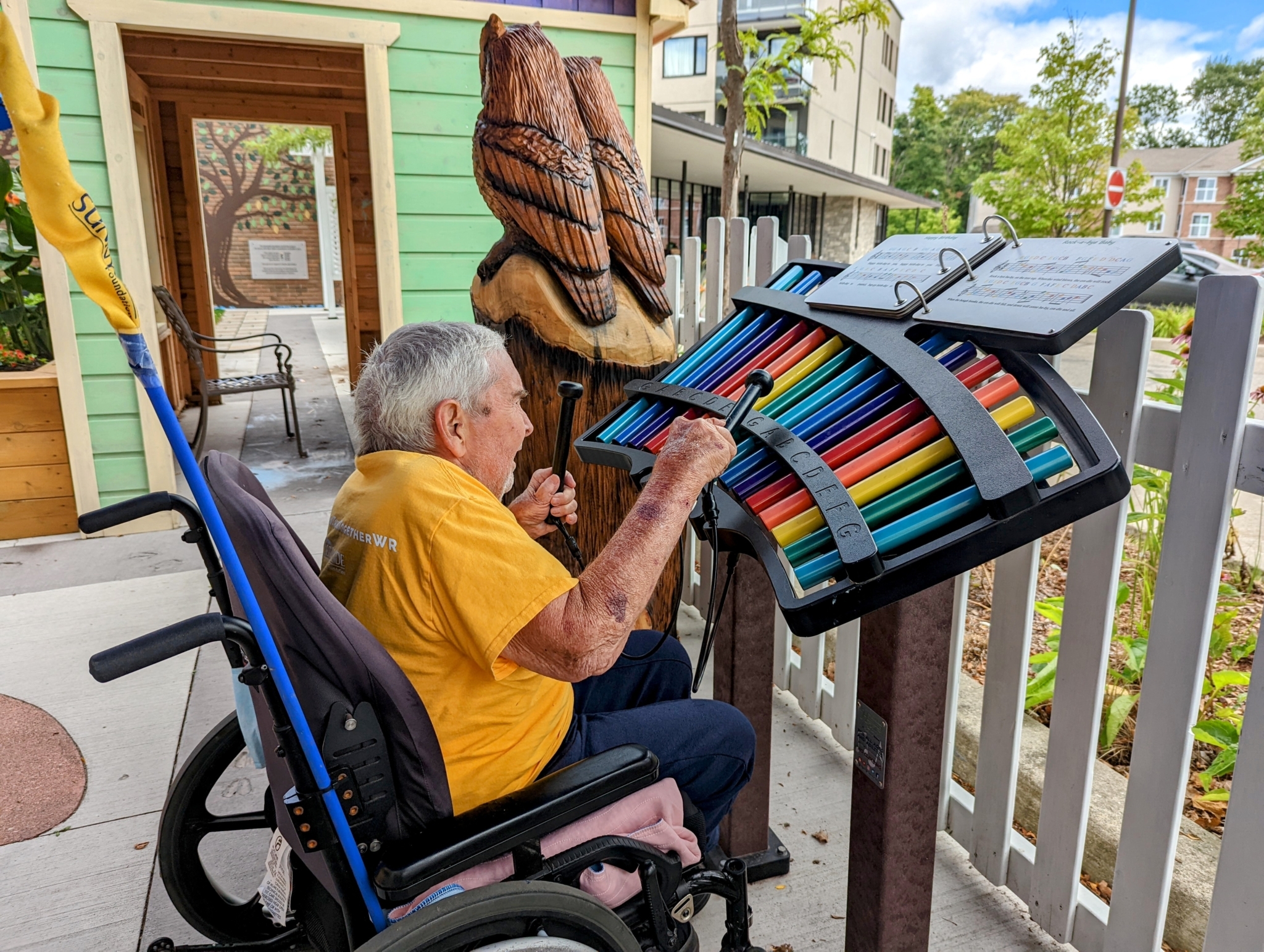 person in wheelchair playing a musical instrument